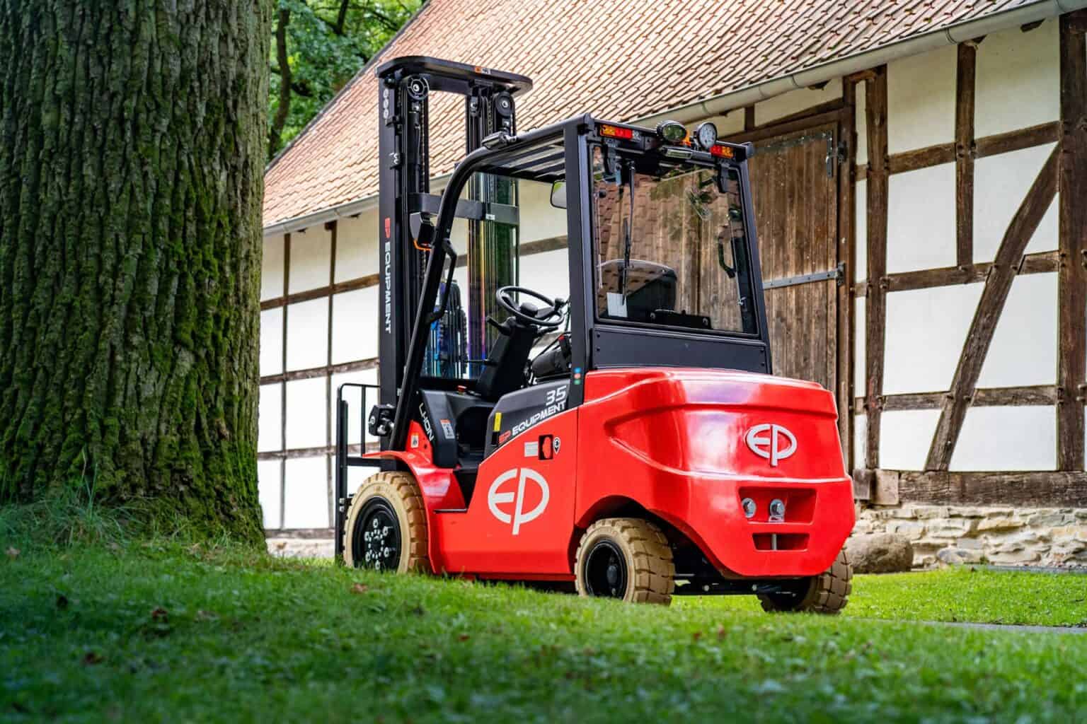 Red EP electric forklift parked outside a warehouse