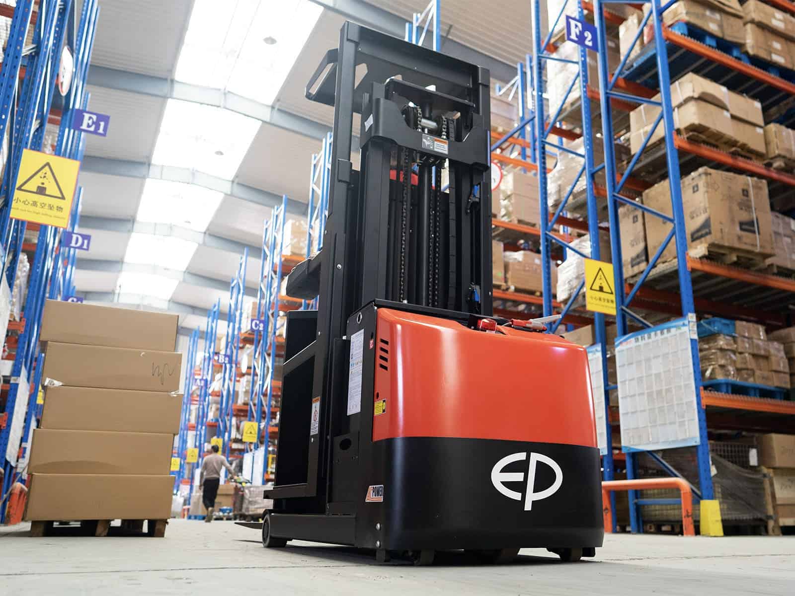 Electric stacker lifting crates in narrow aisle
