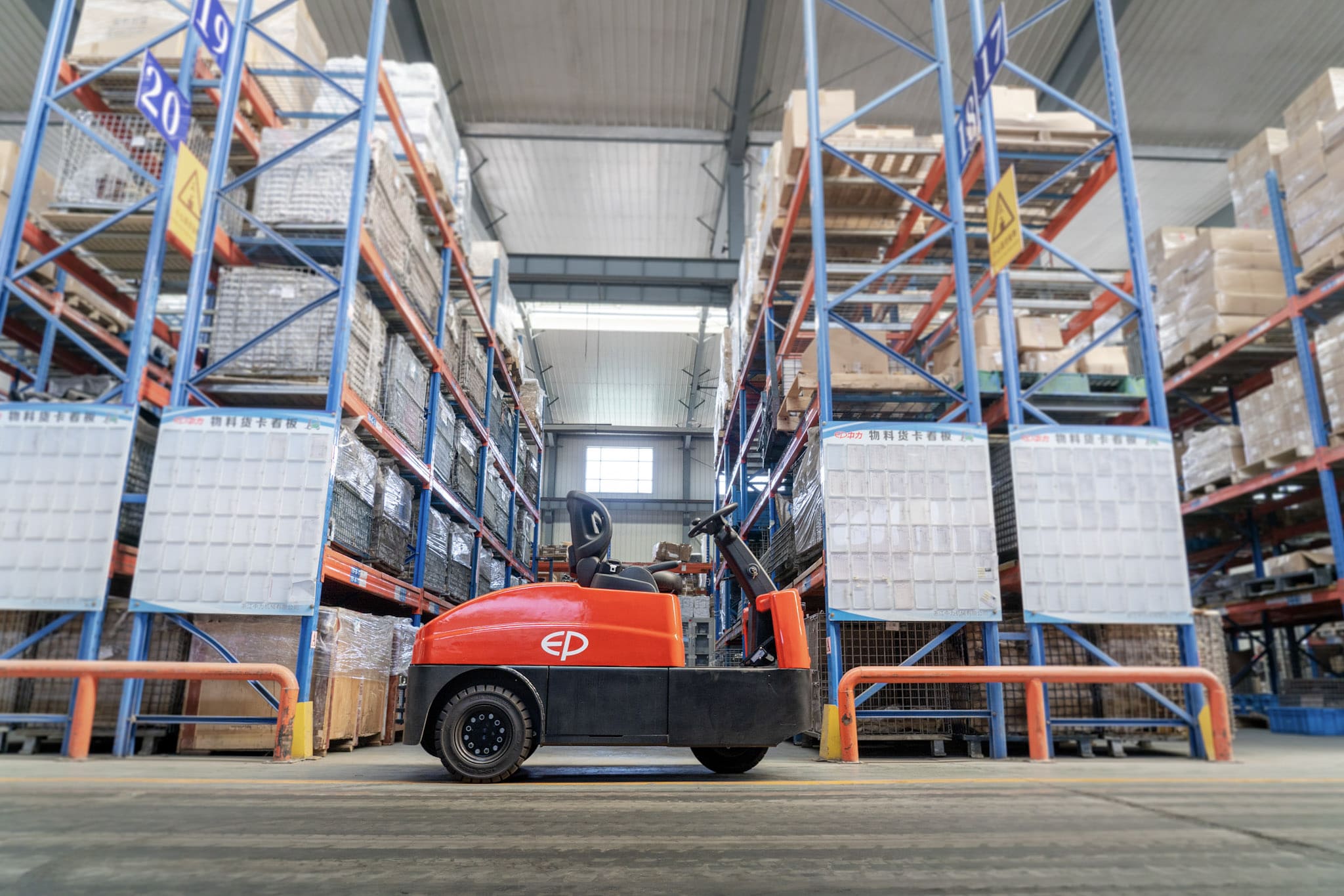 Tow tractor pulling trolleys between workstations