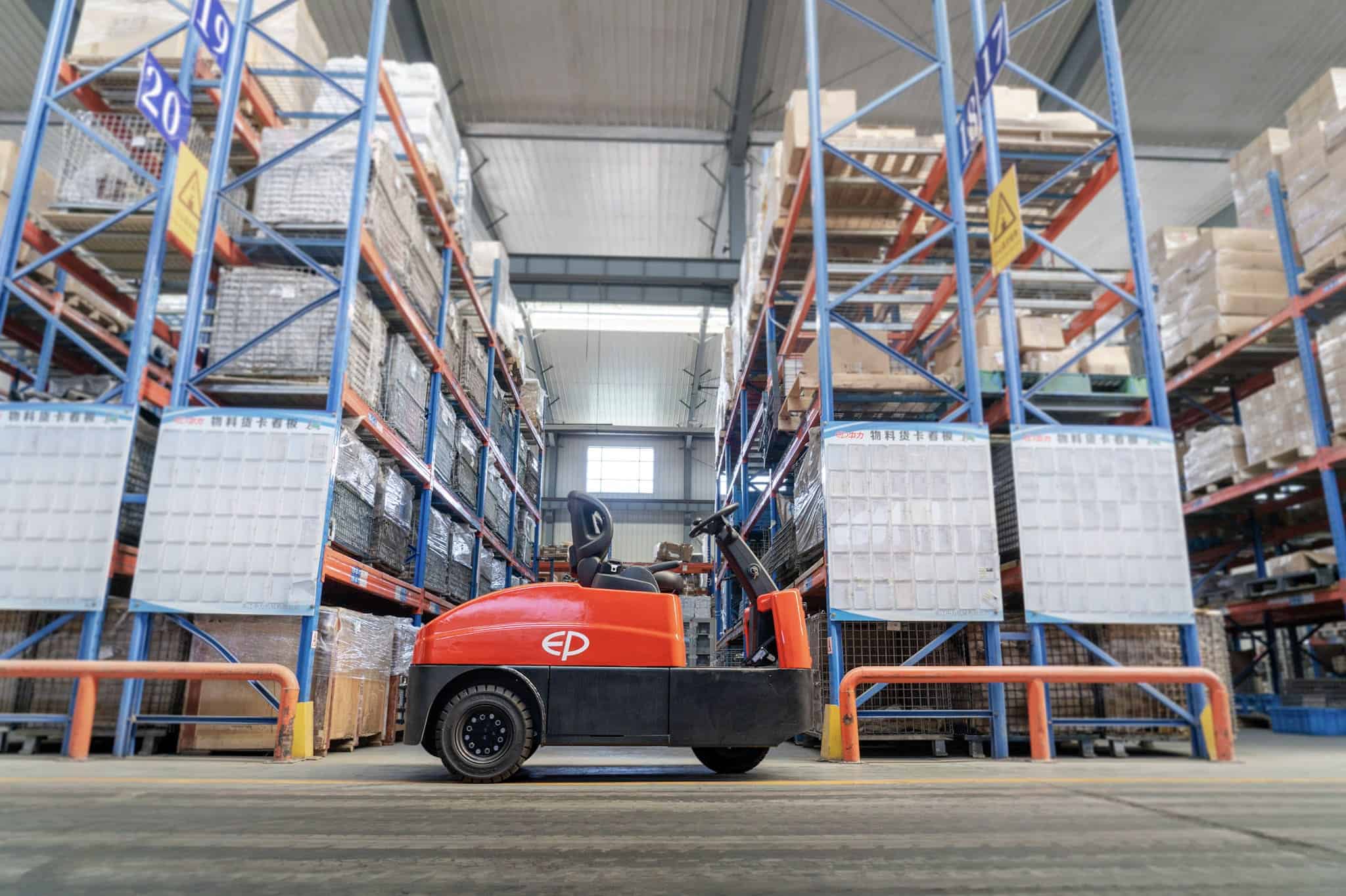 Tow tractor pulling trolleys between workstations