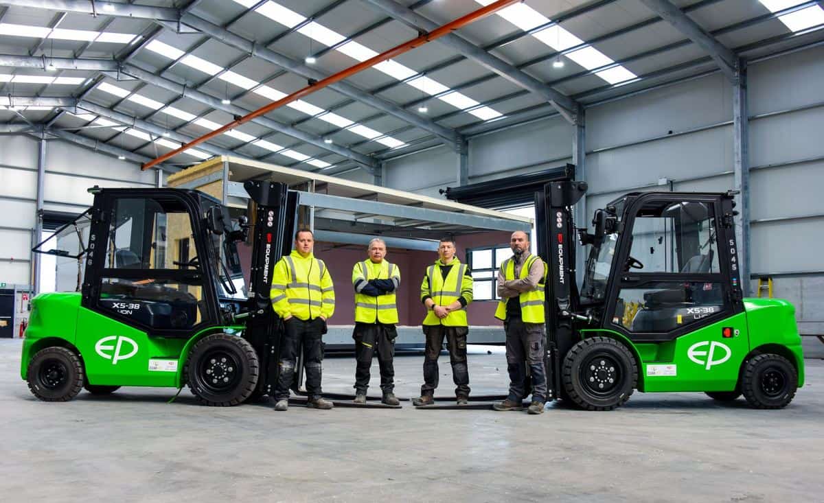 Clearlift team standing between two EP electric forklifts