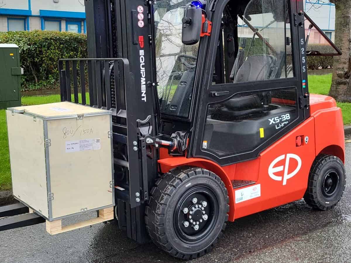Red EP electric cab forklift lifting a wooden crate