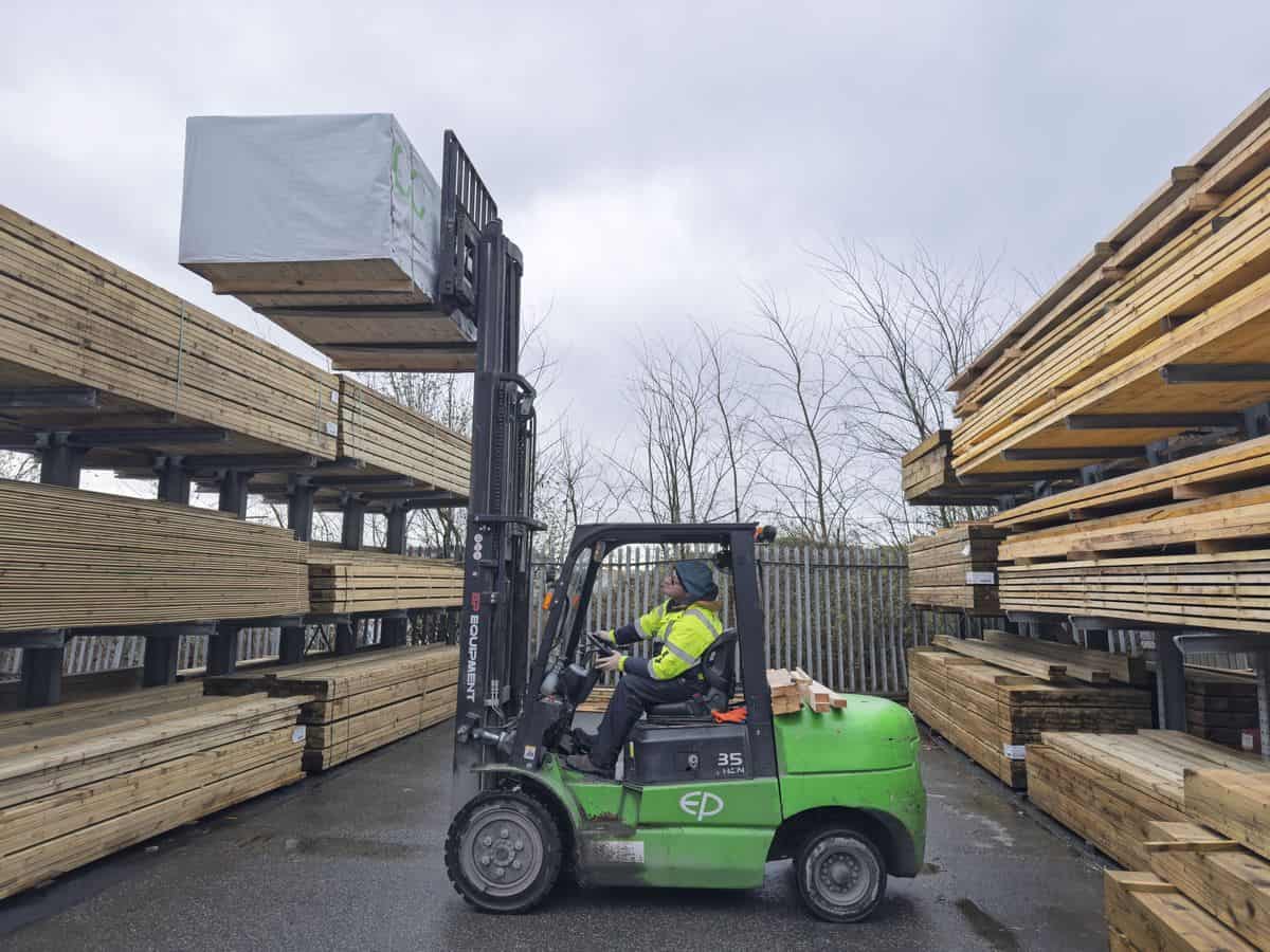 EP 35 lithium-ion forklift lifting a pack of timber to the top of an outdoor rack