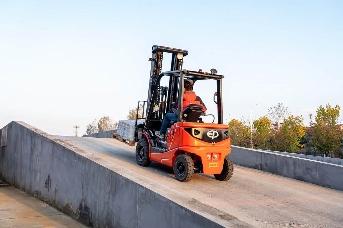 EP electric forklift driving up a concrete yard ramp