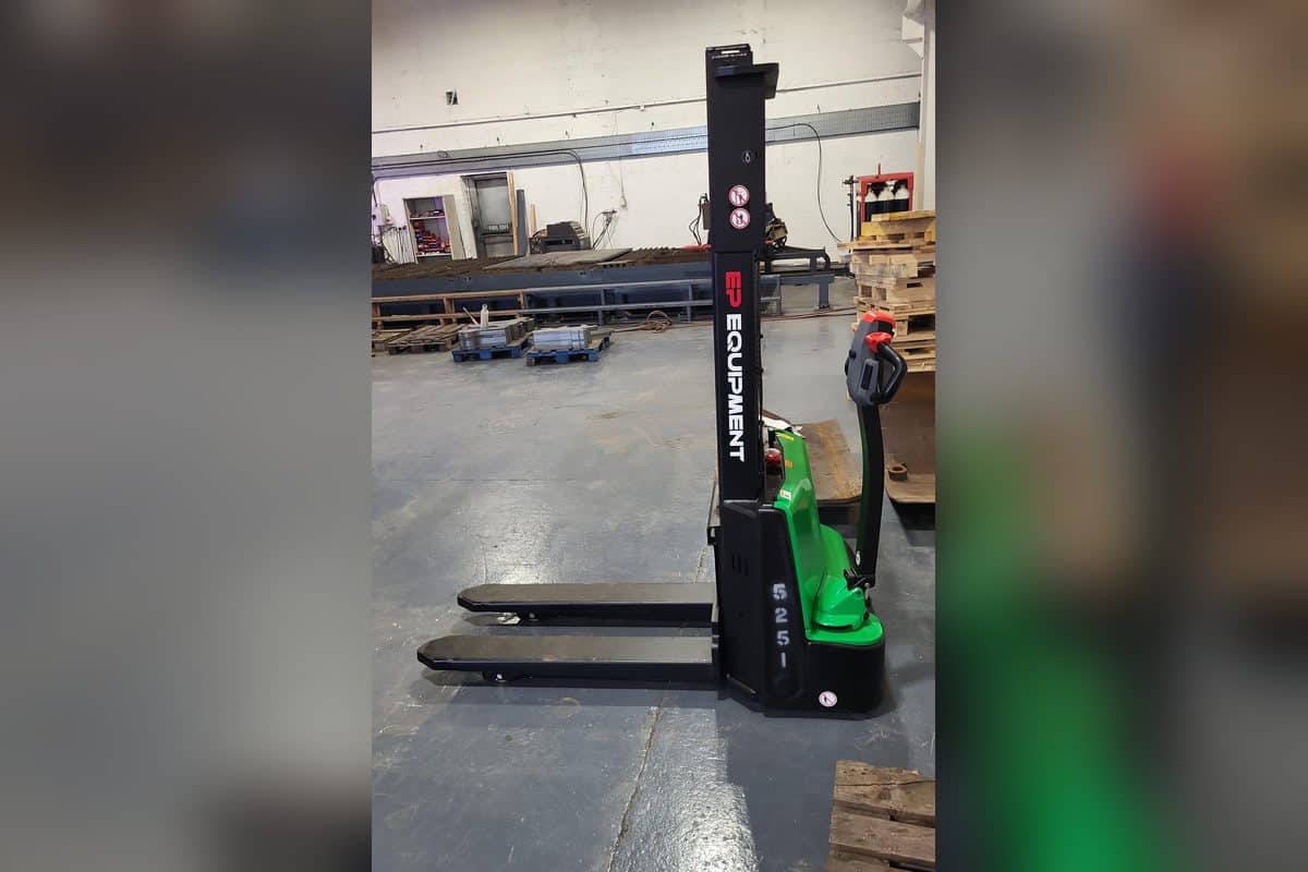 EP walk-behind electric stacker with a tall mast in a warehouse