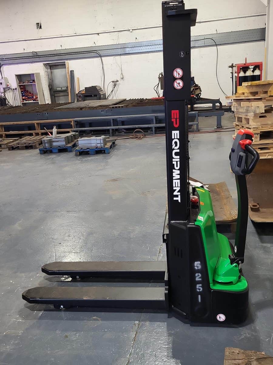 Green EP lithium-ion pallet stacker with a tall mast in a wholesale warehouse