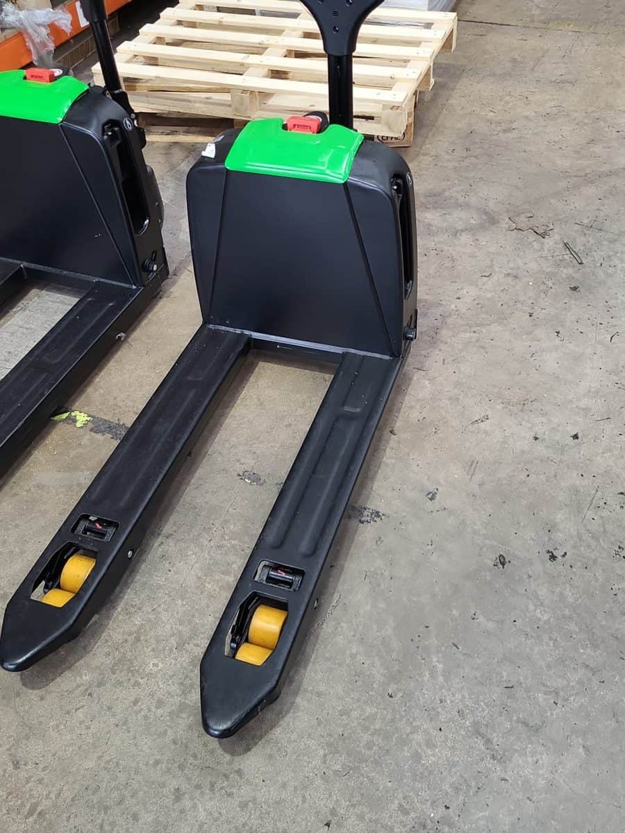 EP F4 lithium-ion electric pallet trucks in a stockroom beside pallets