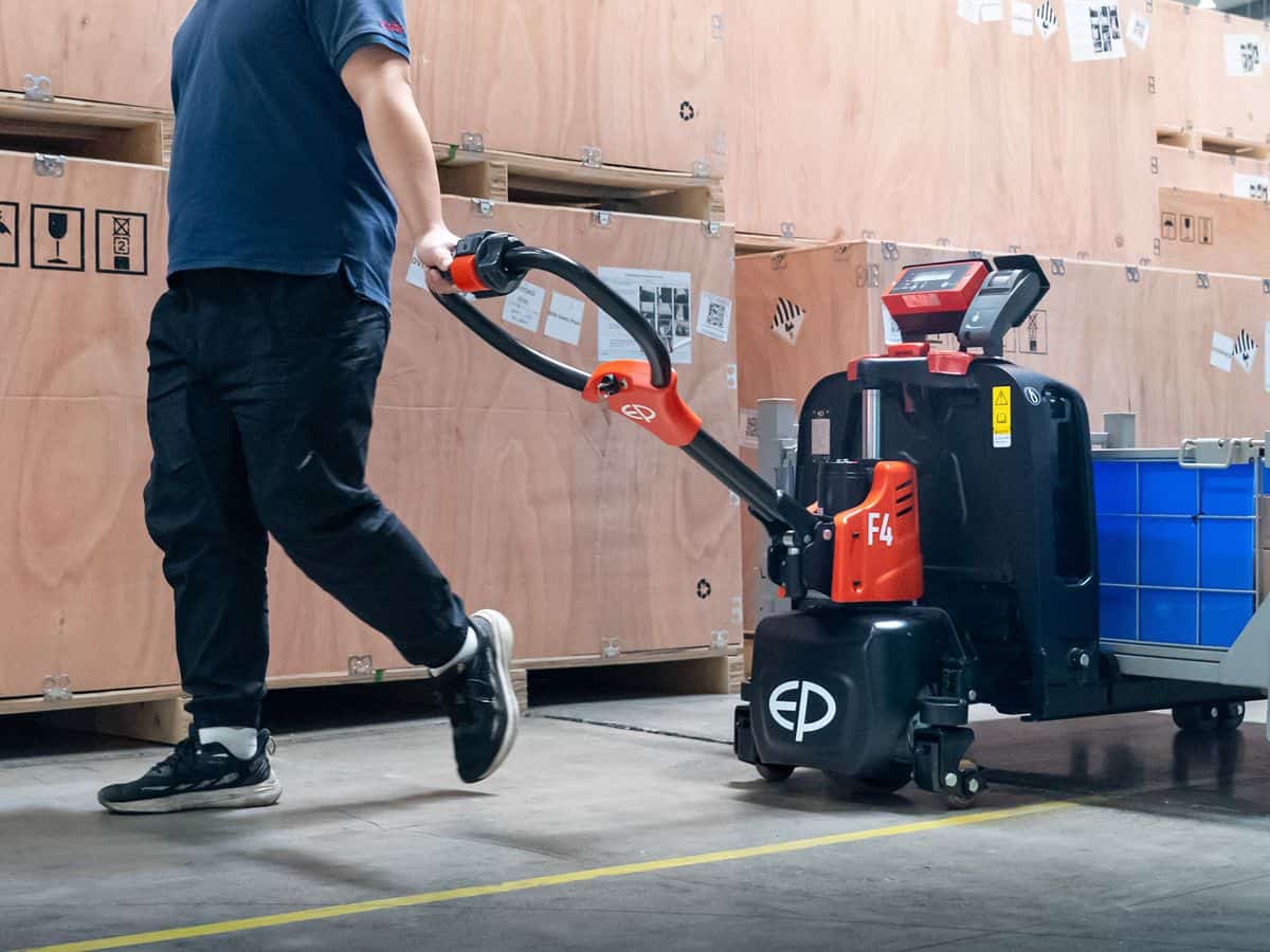EP F4 electric pallet truck with a built-in weigh scale and printer moving a pallet