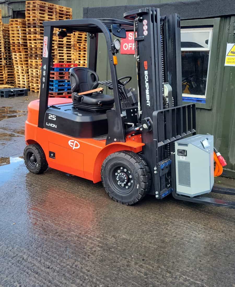EP lithium-ion forklift parked beside its charger in a yard, ready for an opportunity charge