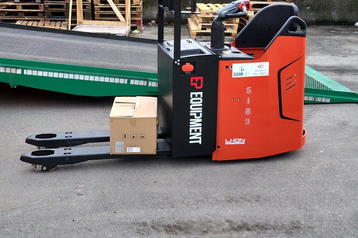 Red EP stand-on ride-on pallet truck carrying a box