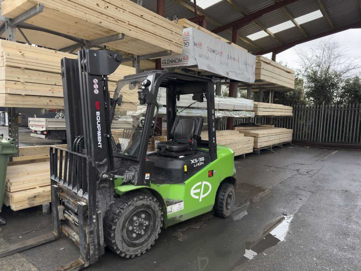 Green EP XS-35 lithium-ion forklift under a covered timber store at a builders merchant